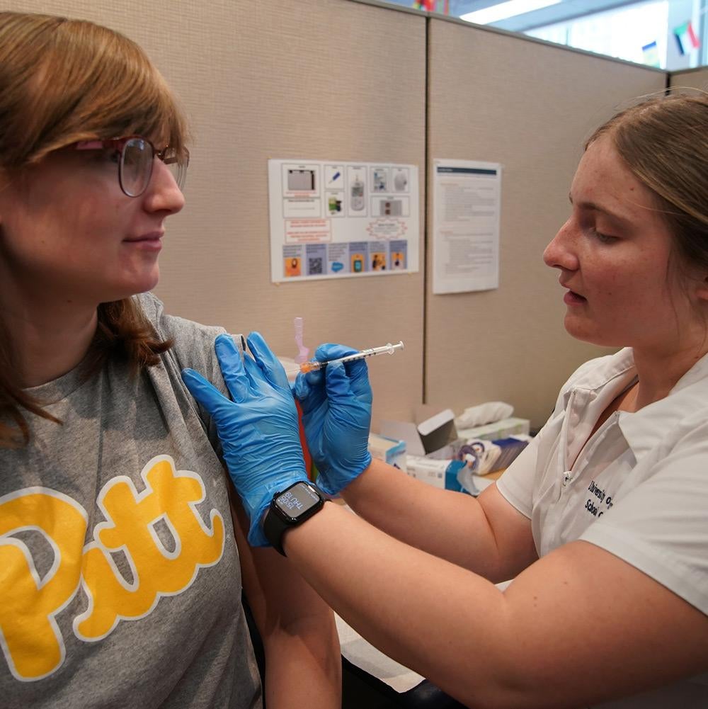 Pitt Student gets the latest Pfizer COVID-19 vaccine from a medical technician at the Pitt Vaccination and Health Connection Hub on 5th Ave.